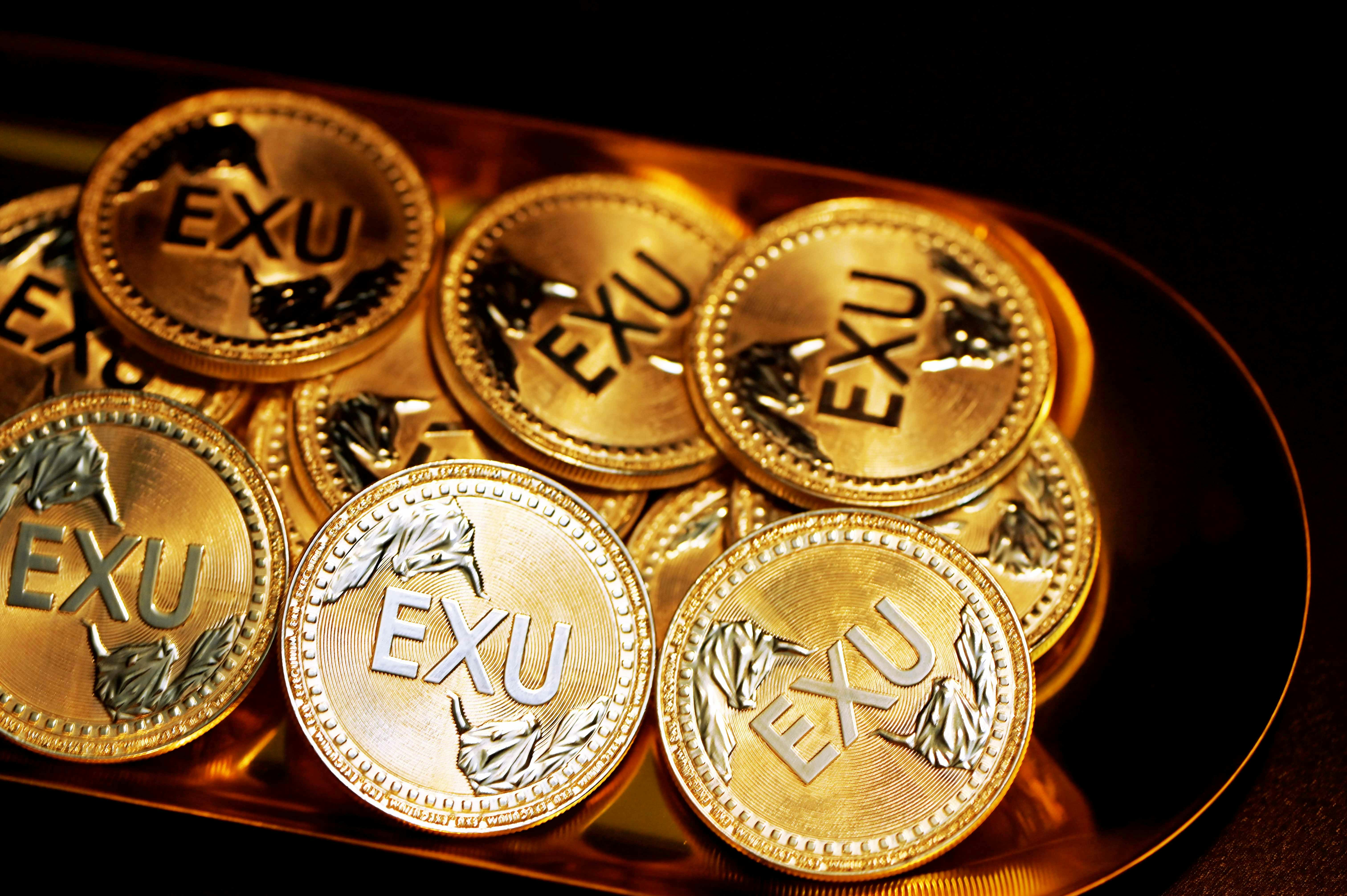 A pile of EXU coins on a golden plate